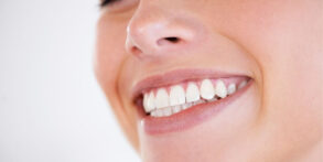 Woman smiling with straight teeth after Invisalign treatment