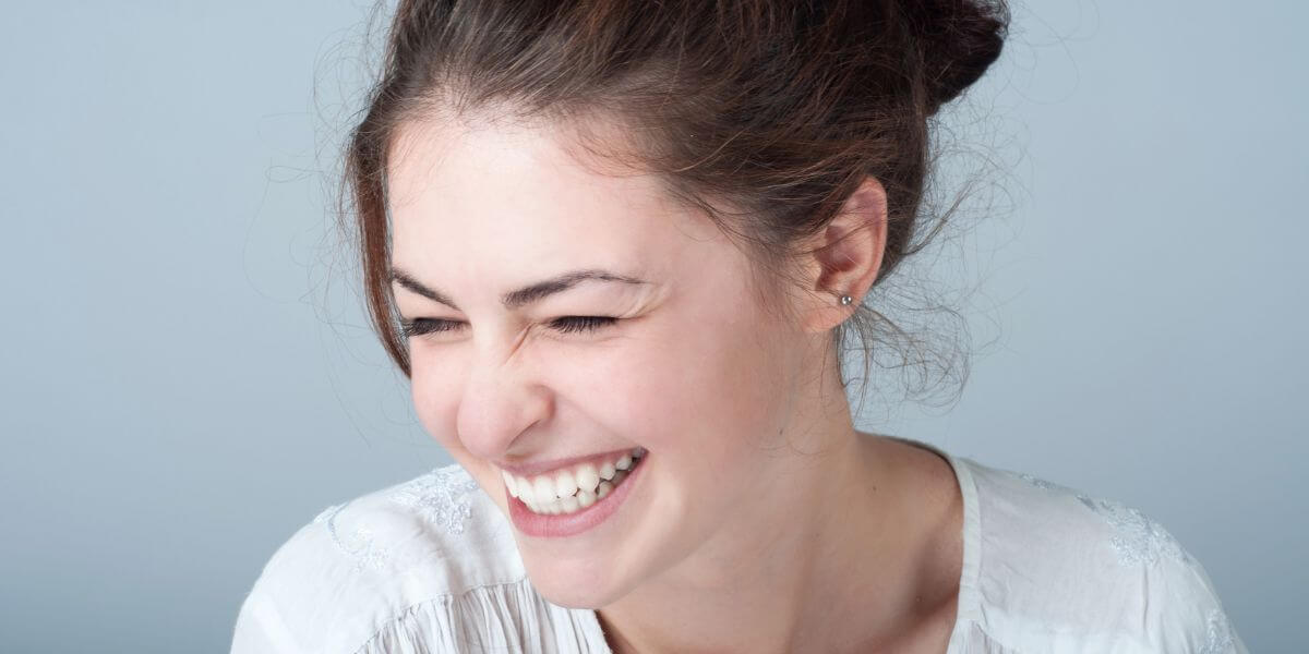 Woman smiling after dental implants surgery