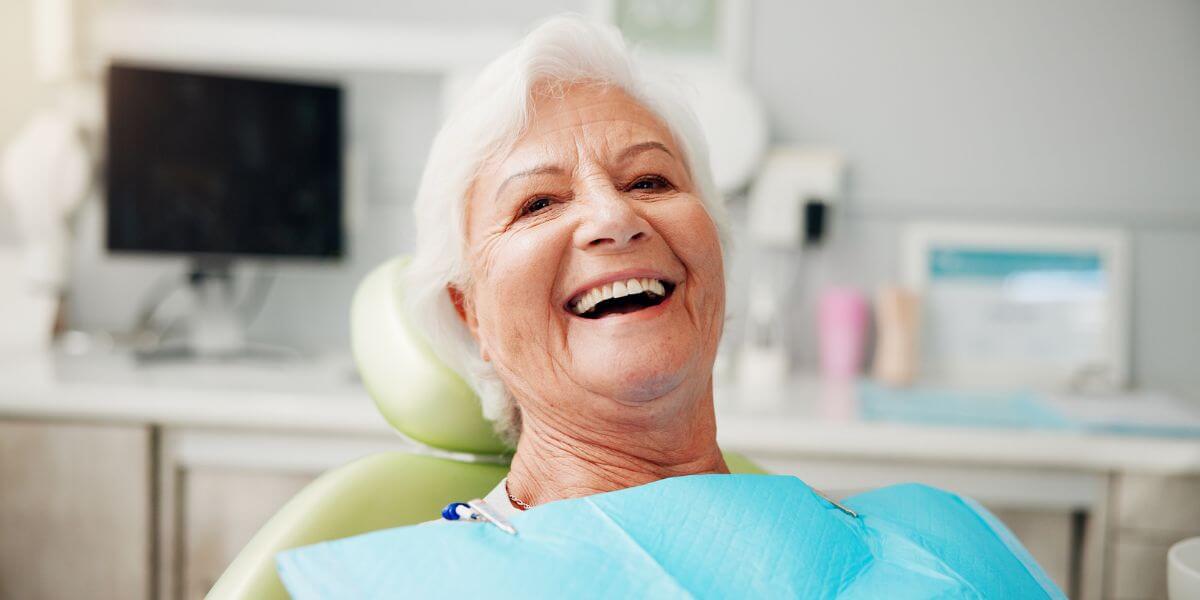 woman smiling after bleeding gum treatment