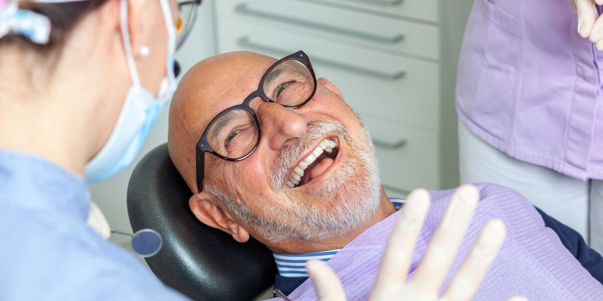 man smiling with dental implants